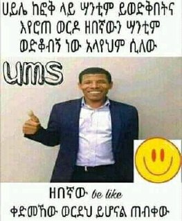 a man in a suit and tie is giving a thumbs